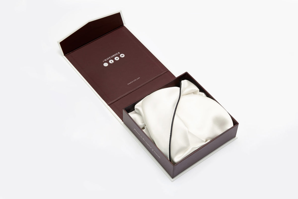 ivory silk pillowcase with charcoal border piping folded and placed inside a gift box by Mayfairsilk