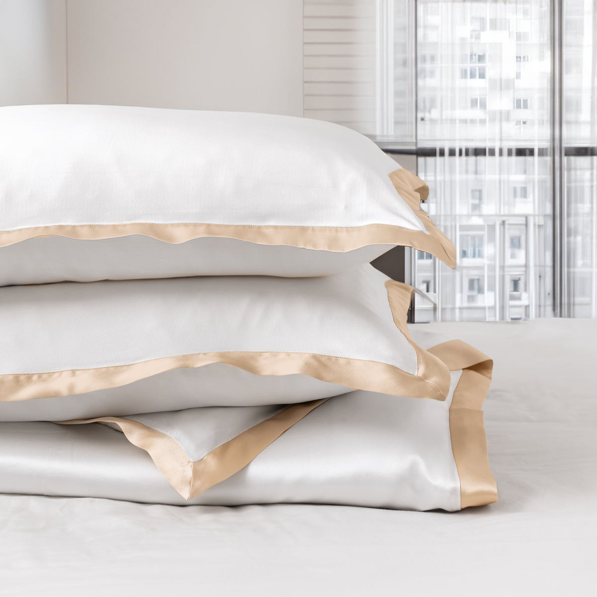 Bedroom with White Silk Sheets with Champagne Oxford border stacked on the bed