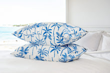 Load image into Gallery viewer, Two silk pillowcases stacked on top of each other with The Palms print in blue on Ivory background. 
