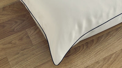 Short clip closeup of ivory pillowcase with charcoal piping