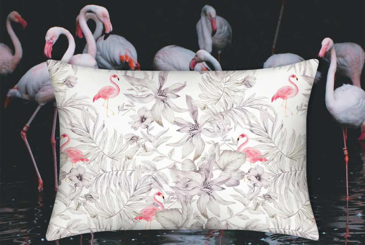 Flamingos silk pillowcase in the foreground with a flamboyance of flamingos in the background