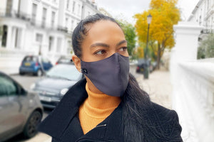 Woman walking on street wearing Midnight Blue Pure Silk Face Covering - MayfairSilk