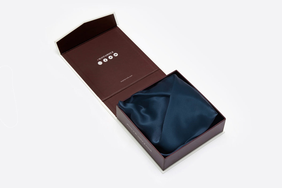 Midnight Blue silk pillowcase folded and shown in luxury gift box on white background